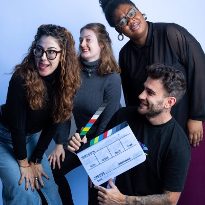 4 people standing in a role play pose of making a movie