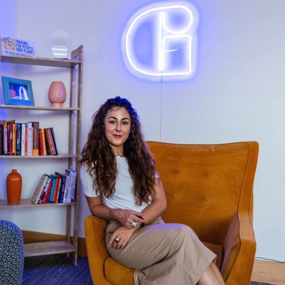 Beatriz from Gorm Media sitting in a chair infront of a GORM sign.