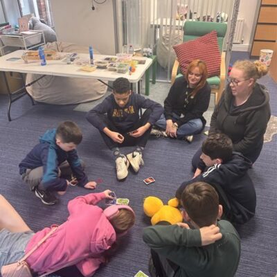 Group of children sitting on the floor in a school setting