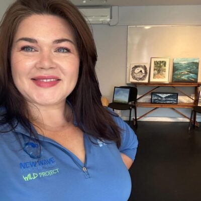 Lady smiling wearing a blue polo shirt