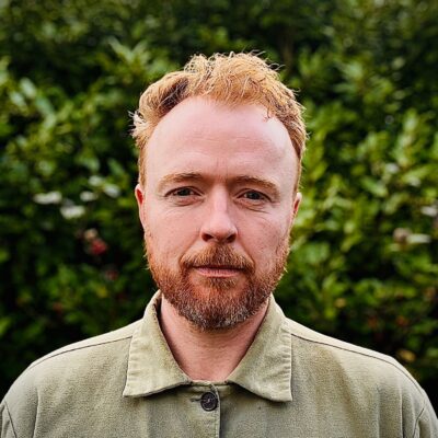 A headshot of a man with red hair and beard