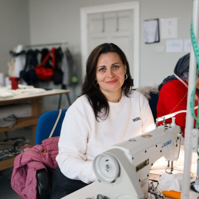 Woman working at sewing machine in textiles studio