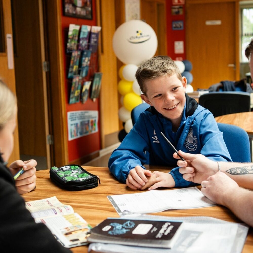 Young person talking to an older person about home work