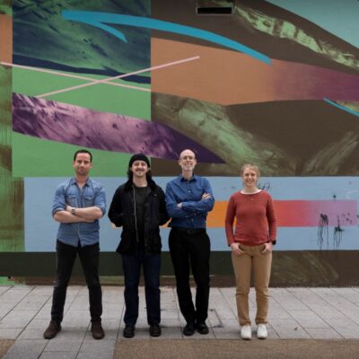 4 people standing on a stage