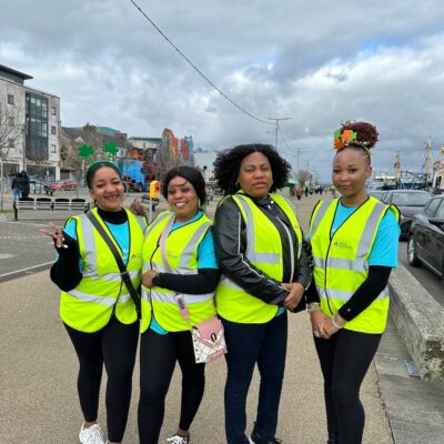 Four women standing on the quays all wearing hi viz vests